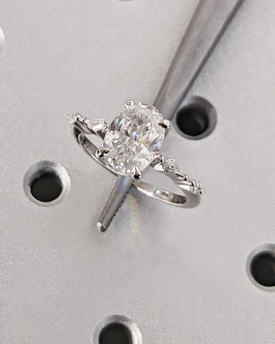 Oval cut engagement ring shown with authenticity certificate