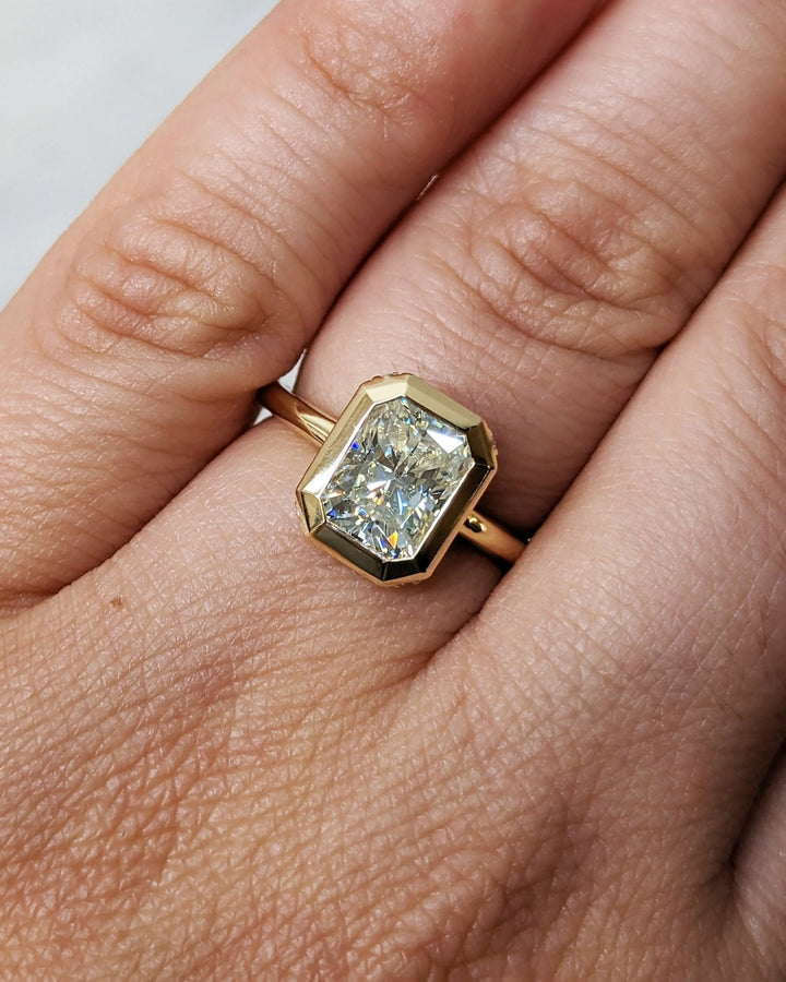 Fine craftsmanship detail on radiant hidden halo engagement ring