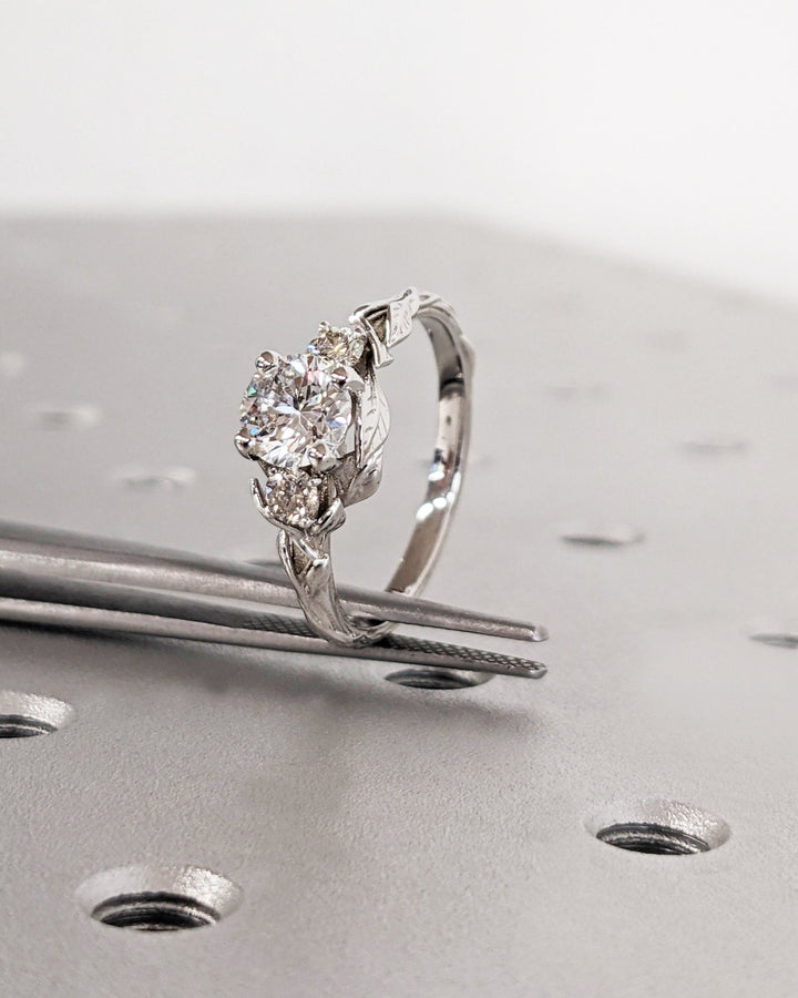 Round three stone engagement ring with IGI certificate and packaging