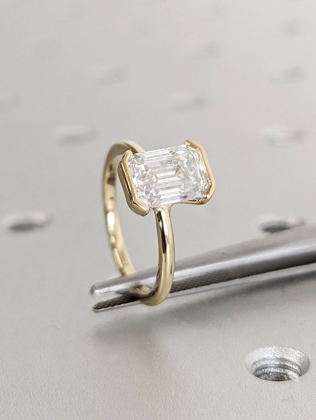 Emerald bezel engagement ring with brilliant diamond sparkle