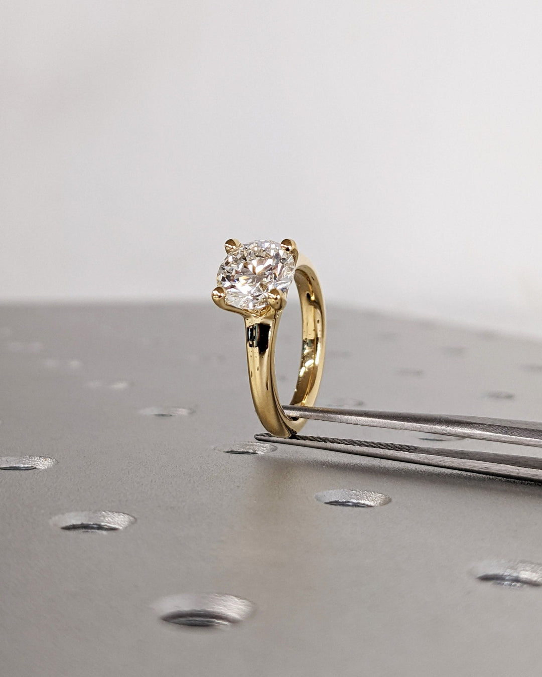 Side angle of round solitaire diamond engagement ring