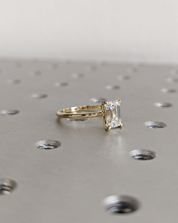 Emerald cut engagement ring side view showing band detail