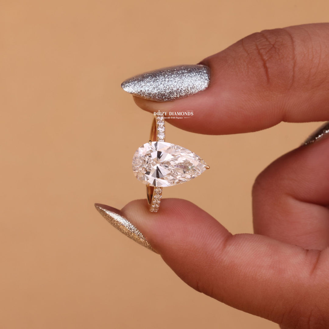 Profile view of pear cut hidden halo engagement ring band