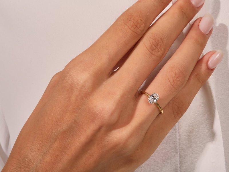 Oval solitaire lab grown diamond ring side profile in gold setting