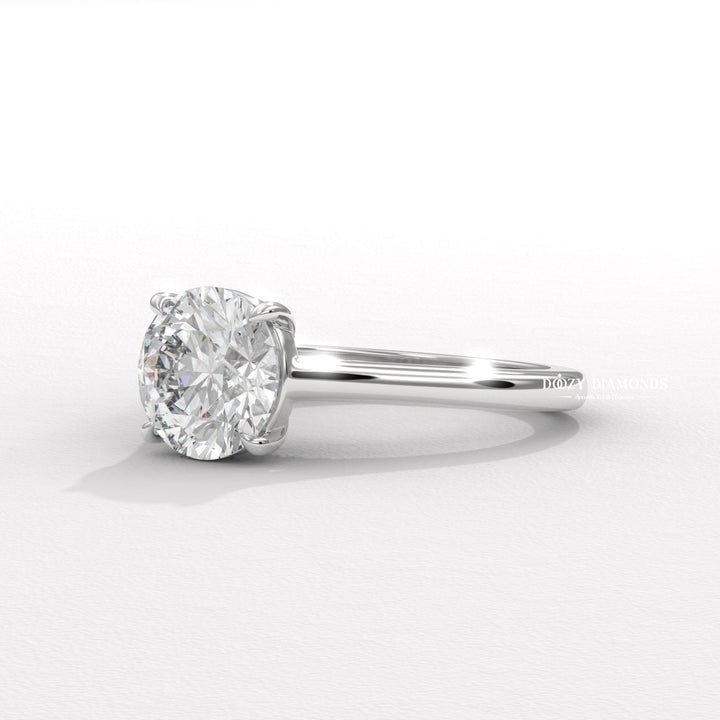 Lifestyle shot of round solitaire diamond ring on hand
