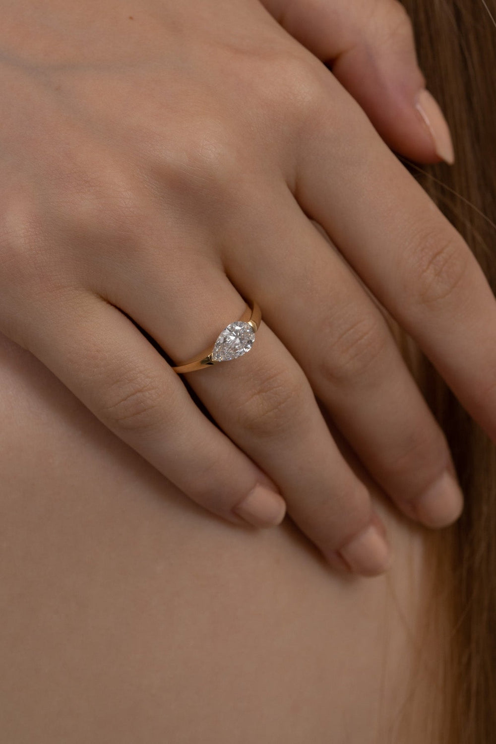 Pear solitaire diamond engagement ring available in multiple metals