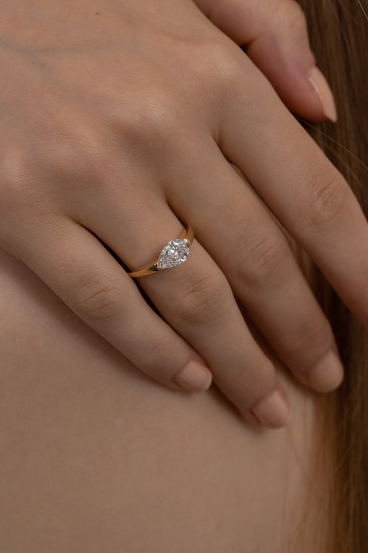 Pear solitaire diamond engagement ring available in multiple metals