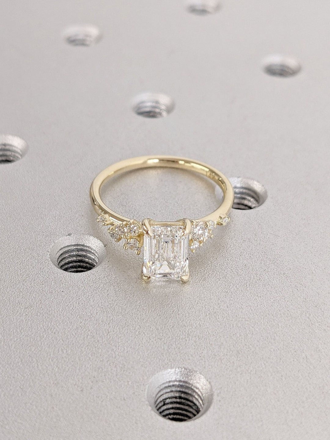 Profile view of emerald cut cluster engagement ring band