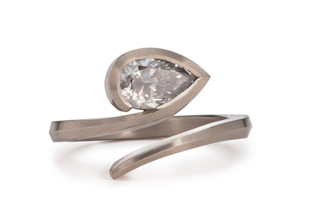 Lifestyle shot of pear solitaire diamond ring on hand
