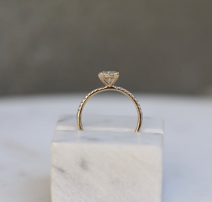 Oval solitaire engagement ring shown on hand for true-to-life sizing