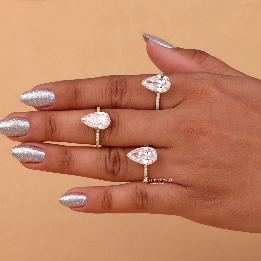 Pear hidden halo engagement ring shown on hand for true-to-life sizing
