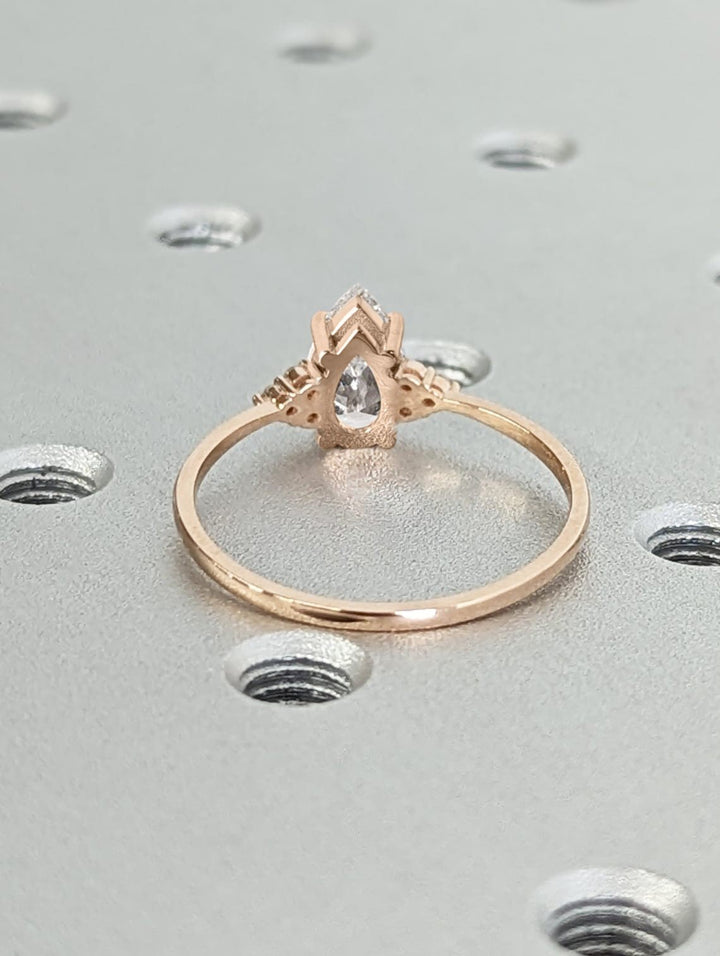 Side angle of pear cluster diamond engagement ring