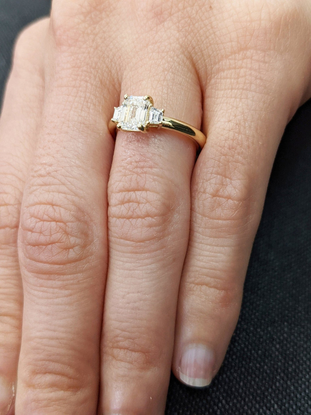 Profile view of emerald cut solitaire engagement ring band