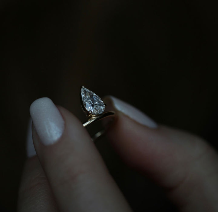 Angled view of pear cut diamond in solitaire setting
