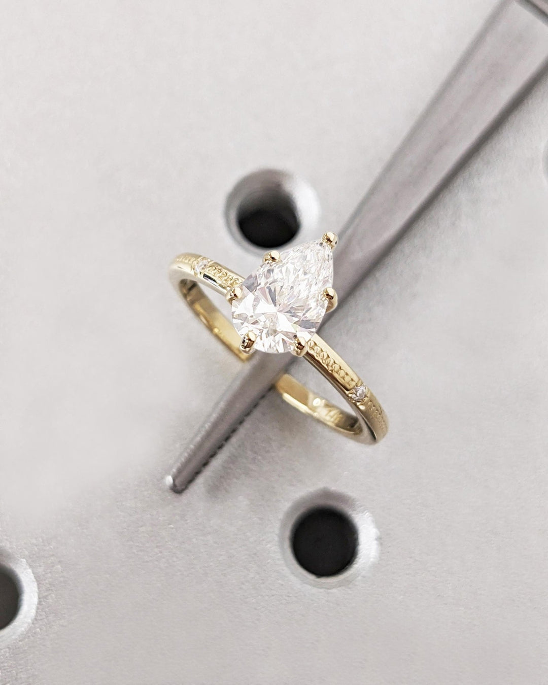 Lifestyle shot of pear solitaire diamond ring on hand
