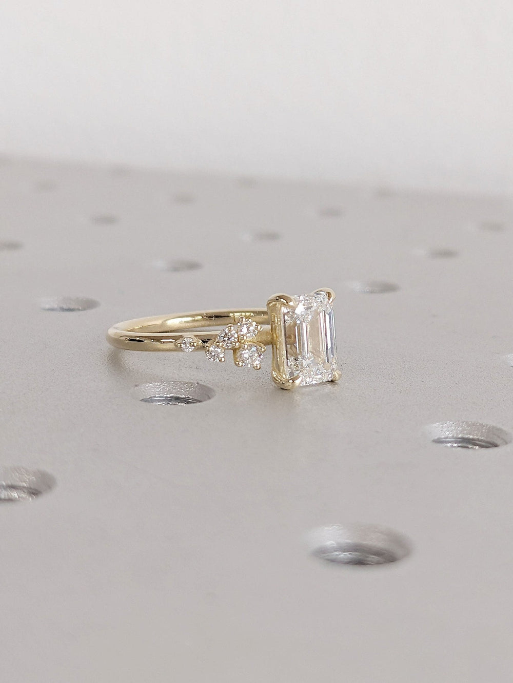 Unboxing view of emerald cut cluster diamond engagement ring