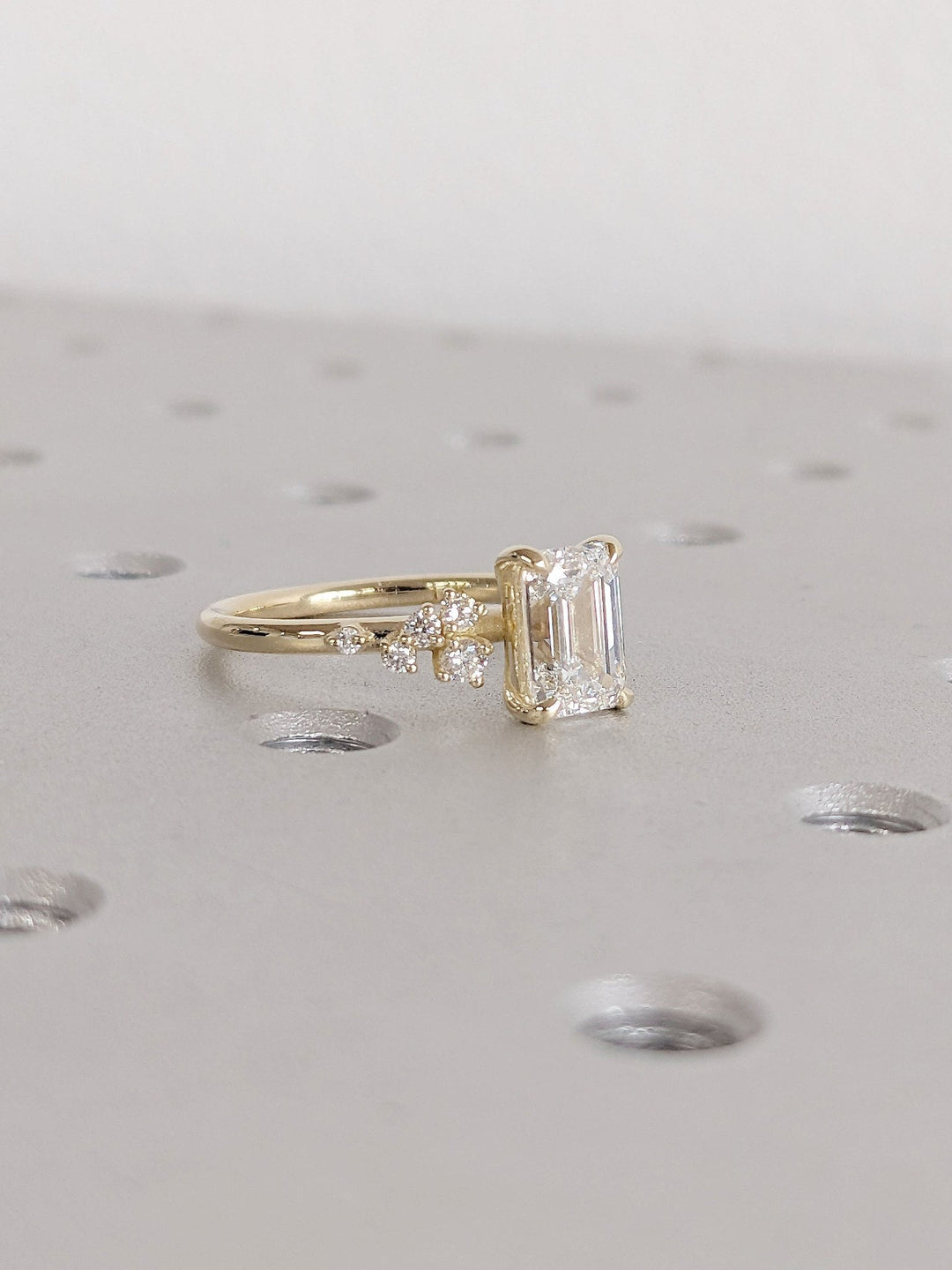 Unboxing view of emerald cut cluster diamond engagement ring