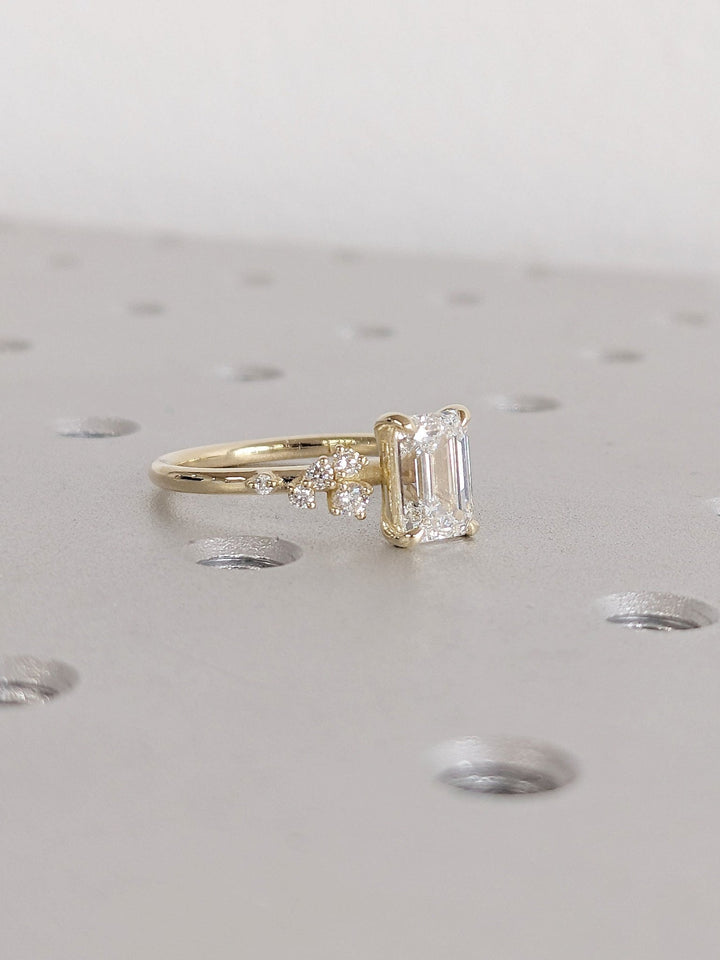 Unboxing view of emerald cut cluster diamond engagement ring