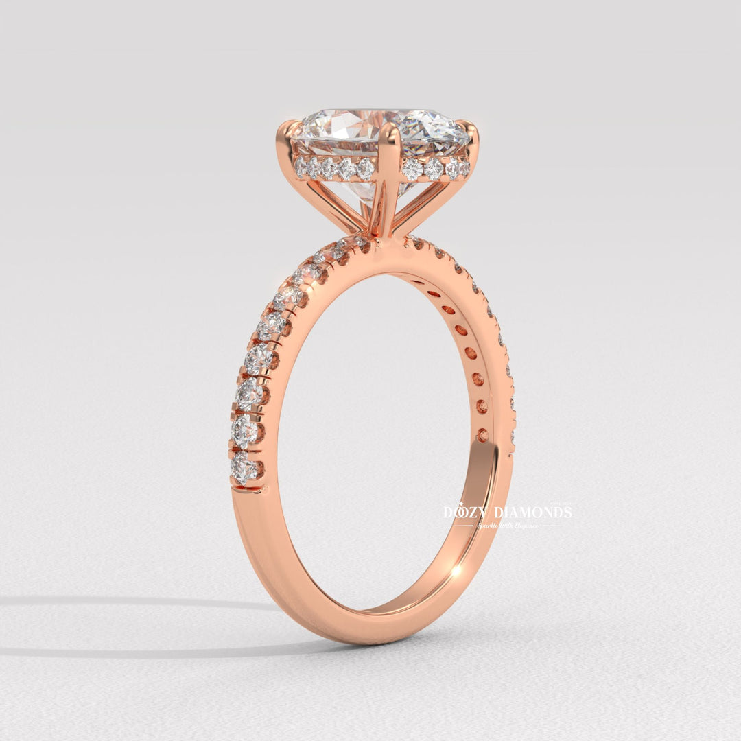 Oval hidden halo engagement ring shown on hand for true-to-life sizing