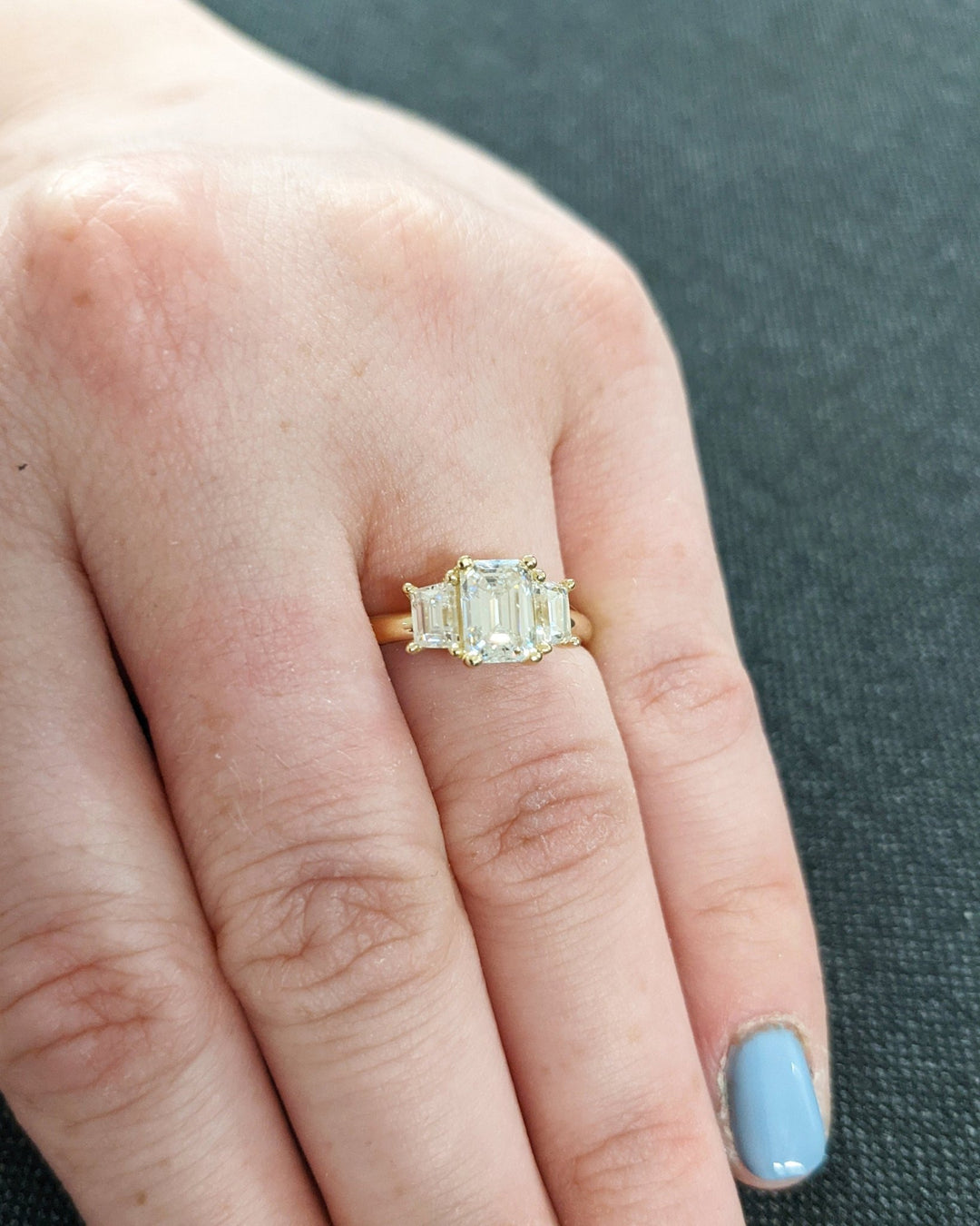 Emerald solitaire engagement ring photographed in natural light