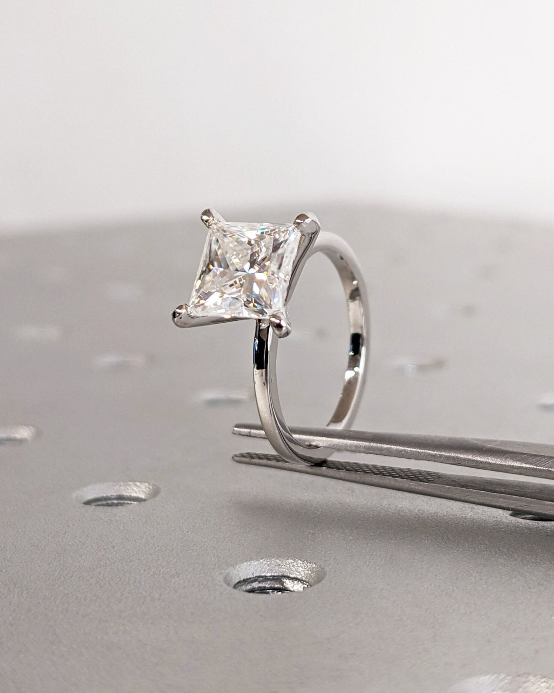 Profile view of princess cut solitaire engagement ring band