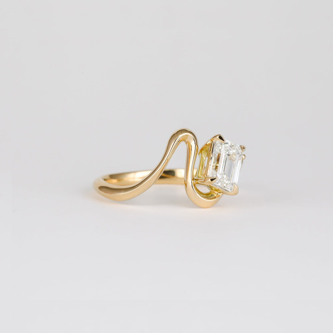 modern luxury ring, elegant bridal ring, designer emerald ring, emerald statement ring, sophisticated bridal ring, contemporary luxury ring, iconic engagement ring, luxury love ring.