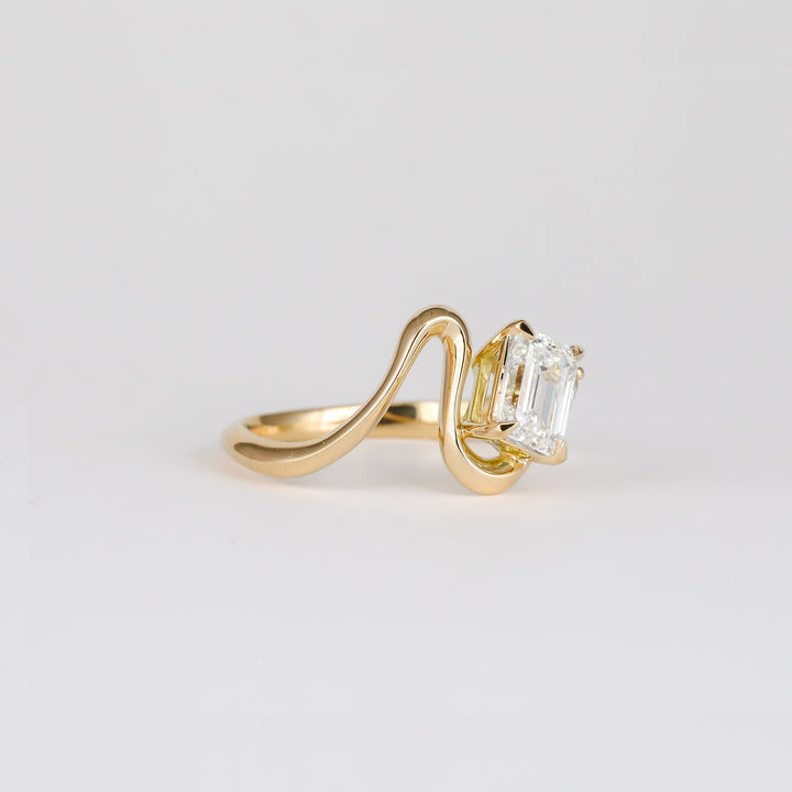 modern luxury ring, elegant bridal ring, designer emerald ring, emerald statement ring, sophisticated bridal ring, contemporary luxury ring, iconic engagement ring, luxury love ring.