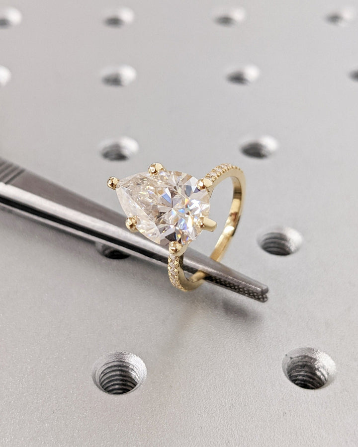 Fine craftsmanship detail on pear hidden halo engagement ring