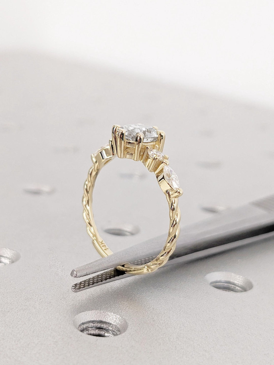 Round cluster diamond ring displayed on jewelry stand
