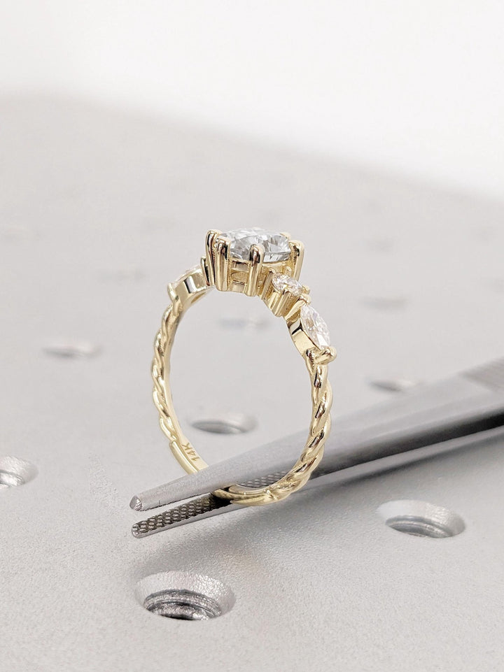 Round cluster diamond ring displayed on jewelry stand