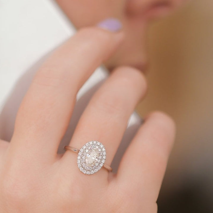 Profile view of oval cut halo engagement ring band