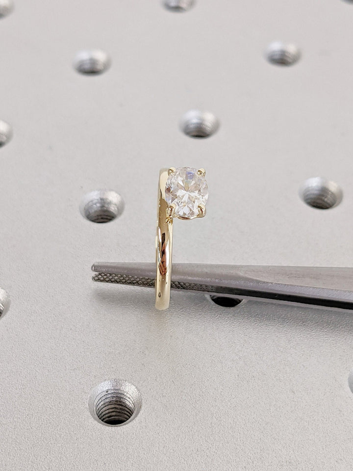 Close-up of oval cut center diamond in east west engagement ring