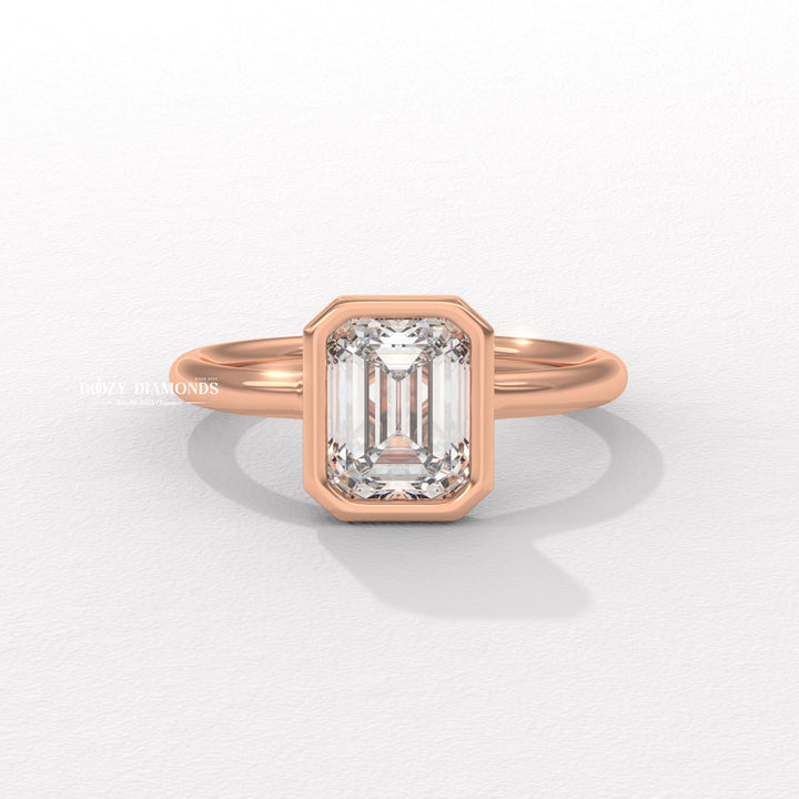 Emerald bezel engagement ring shown on hand for true-to-life sizing