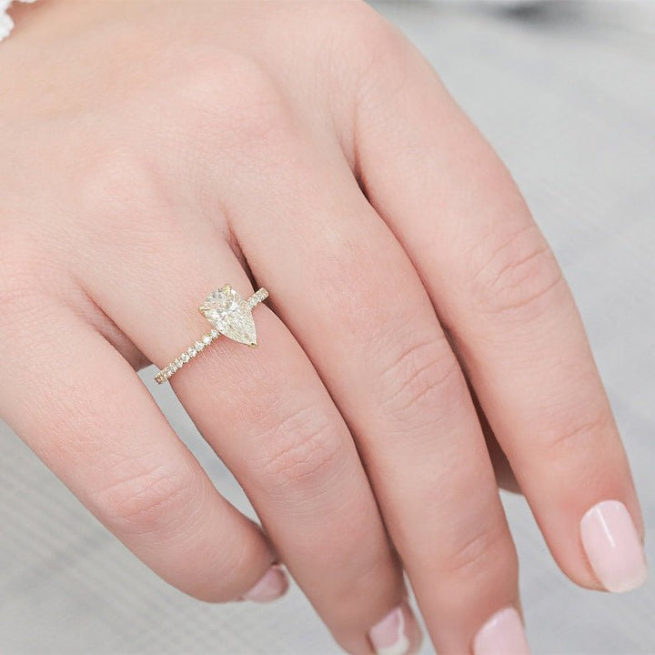 Profile view of pear cut hidden halo engagement ring band