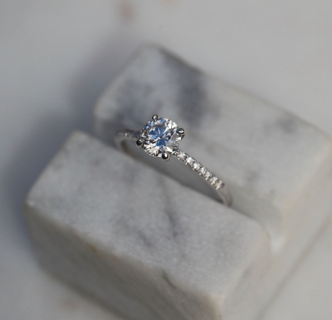 Detailed close-up of round solitaire diamond engagement ring