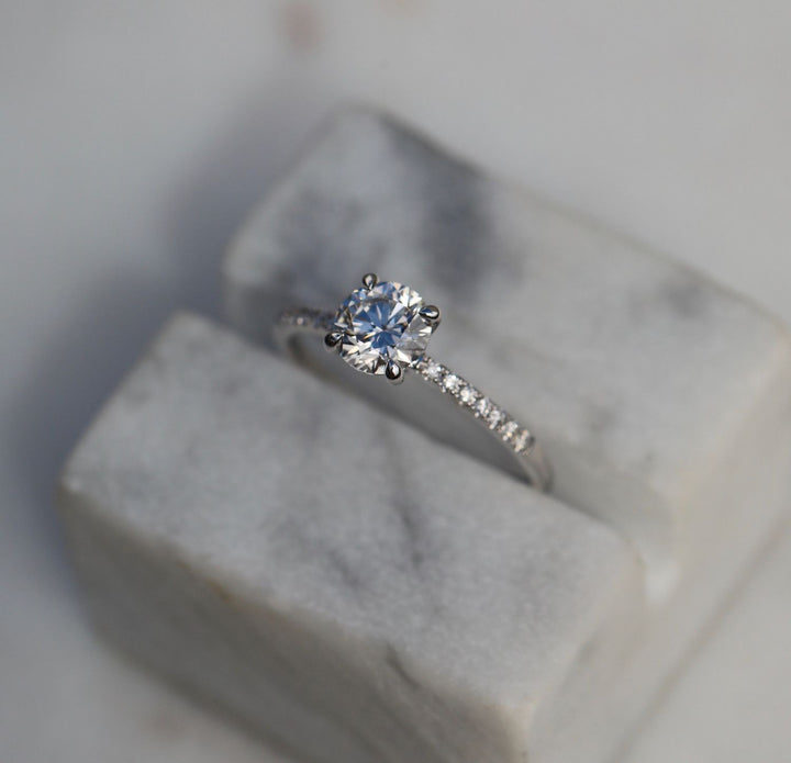 Detailed close-up of round solitaire diamond engagement ring