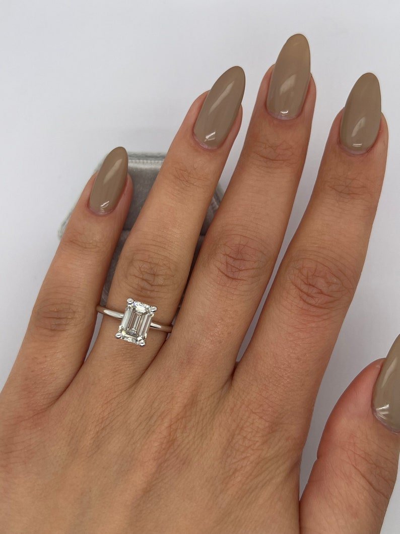 Emerald solitaire engagement ring finished in polished solid gold
