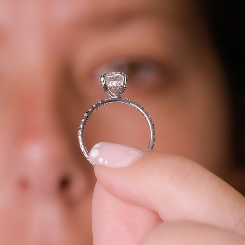 Round hidden halo engagement ring close-up showing F/VS1 diamond clarity