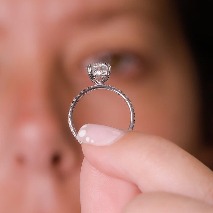 Round hidden halo engagement ring close-up showing F/VS1 diamond clarity
