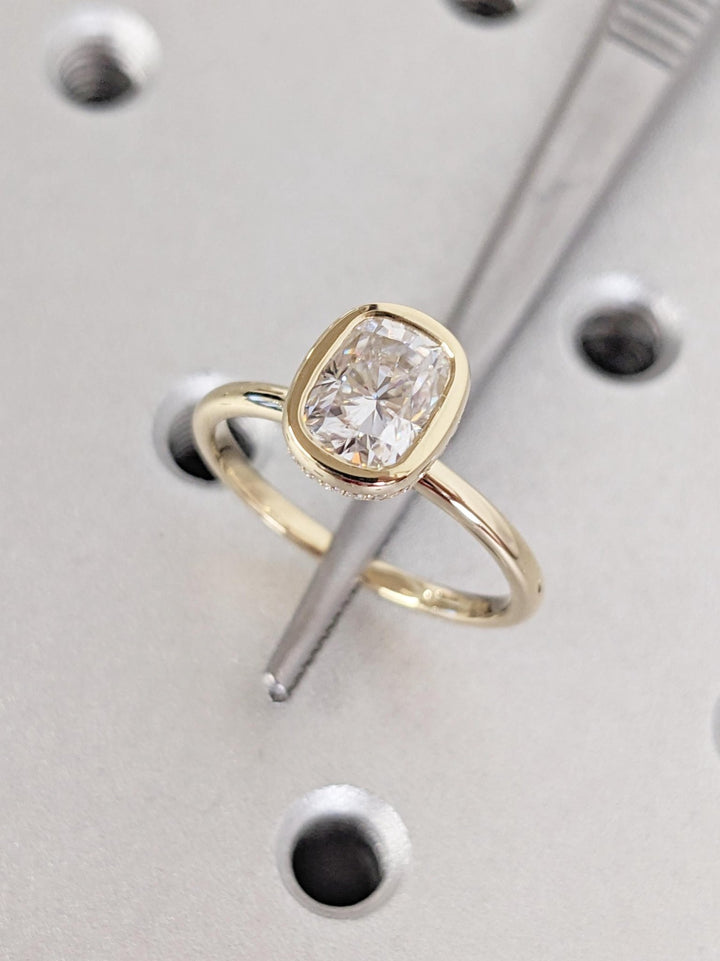 Macro shot of cushion cut diamond facets in hidden halo ring setting