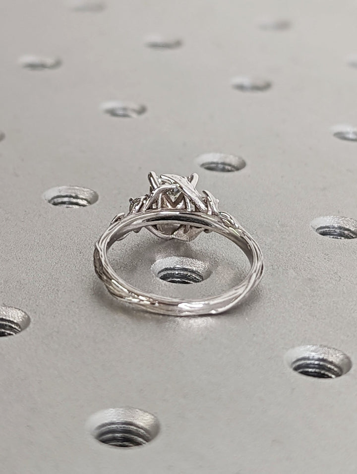 Princess cut engagement ring shown with authenticity certificate