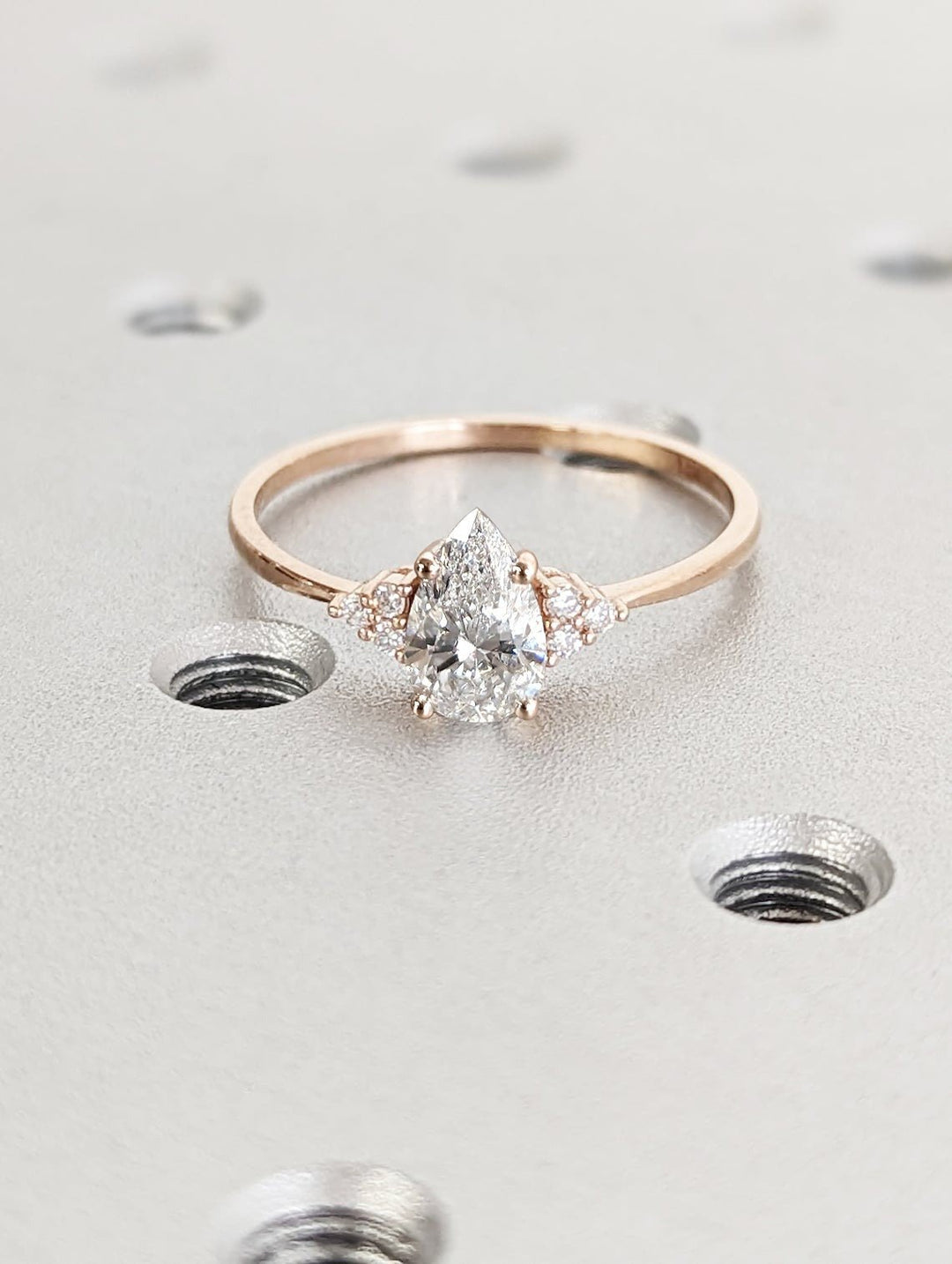 Pear cluster engagement ring viewed from the side