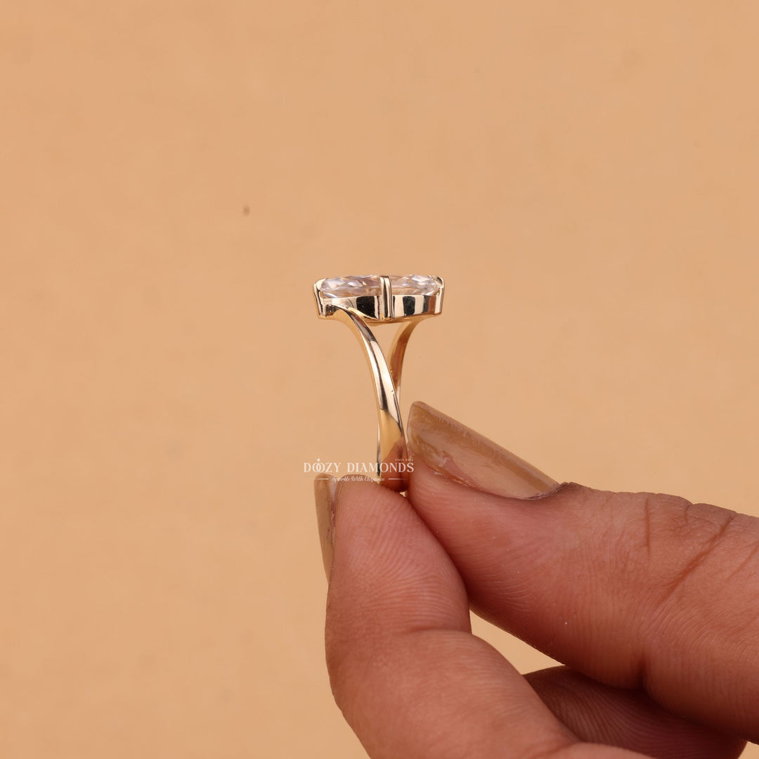 Detailed close-up of marquise solitaire diamond engagement ring