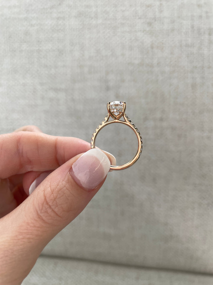 hidden halo wedding ring, pave wedding ring, oval cut luxury ring, lab created bridal diamond, modern elegance diamond ring, luxury engagement centerpiece, timeless bridal engagement ring, fine jewelry bridal ring, statement bridal diamond ring, engagement ring glow,