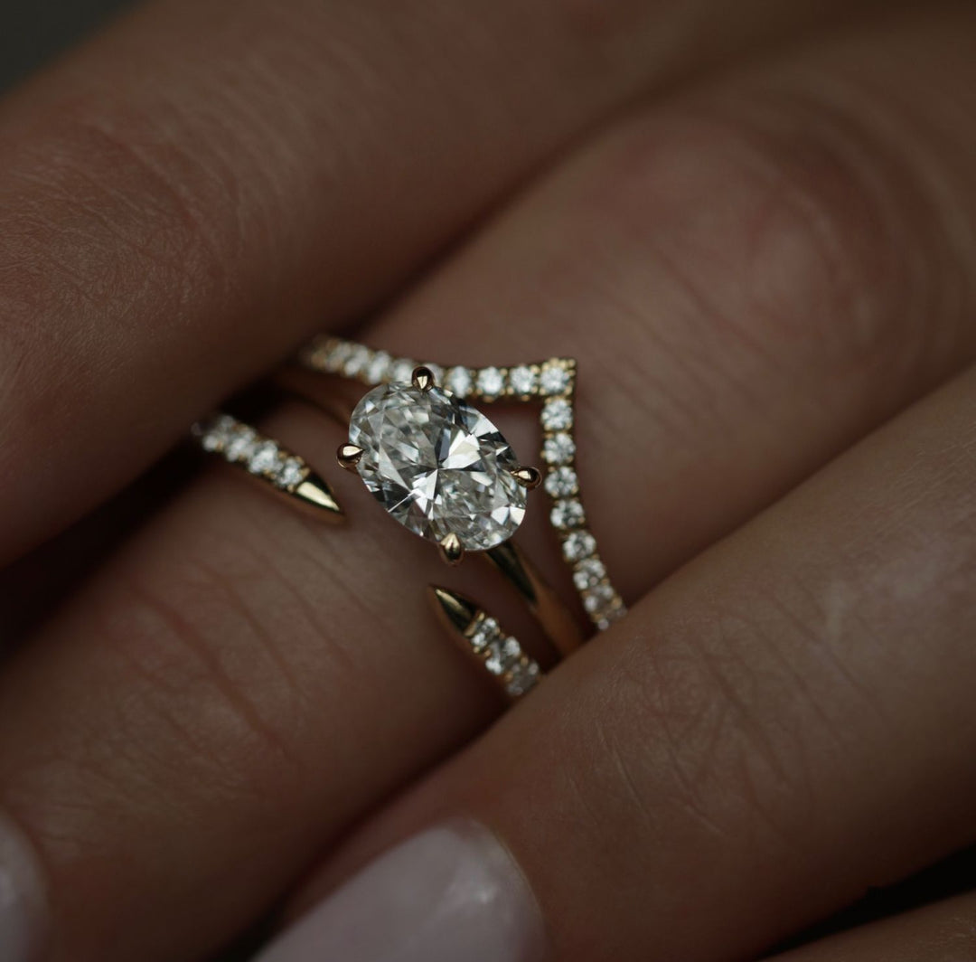 Oval solitaire engagement ring shown on hand for true-to-life sizing