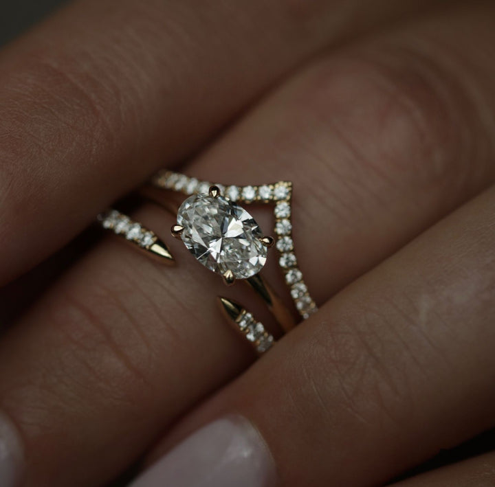 Oval solitaire engagement ring shown on hand for true-to-life sizing