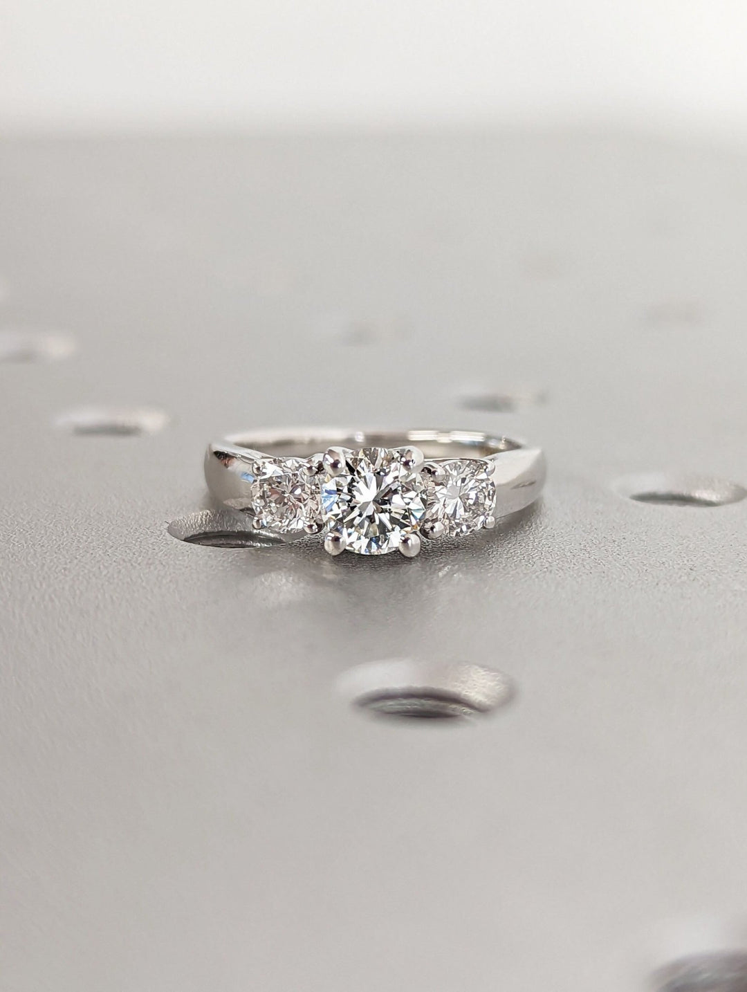 Round cut engagement ring shown with authenticity certificate