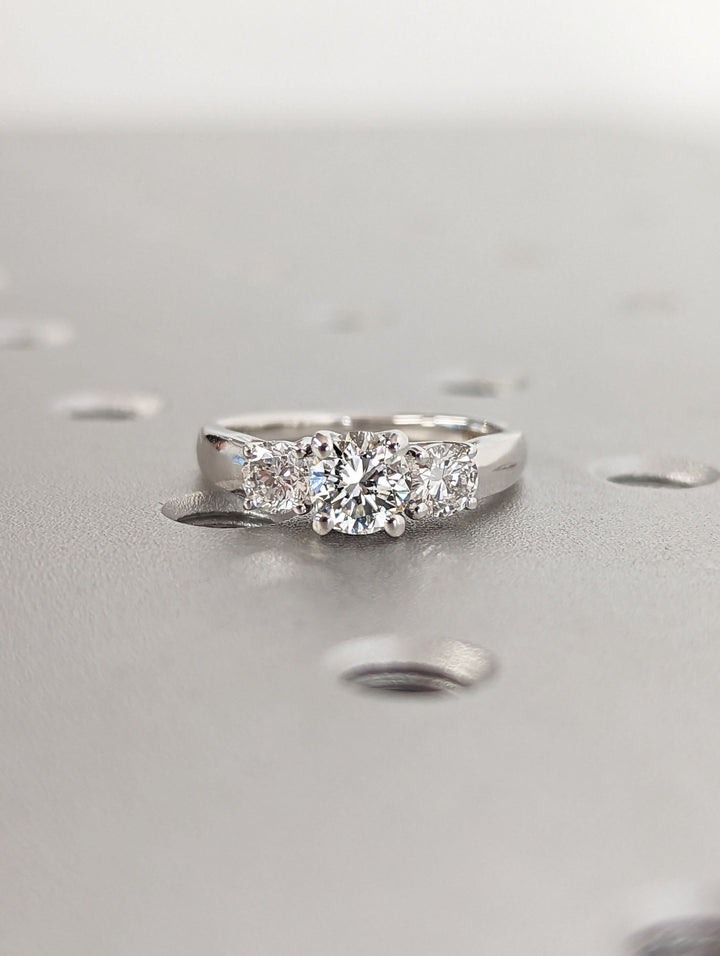 Round cut engagement ring shown with authenticity certificate