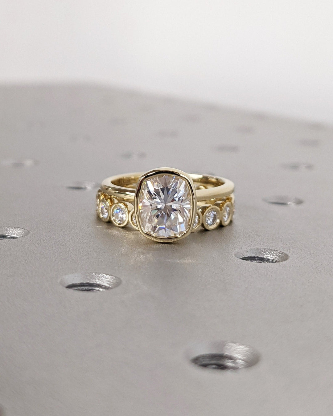 Profile view of cushion cut bezel engagement ring band