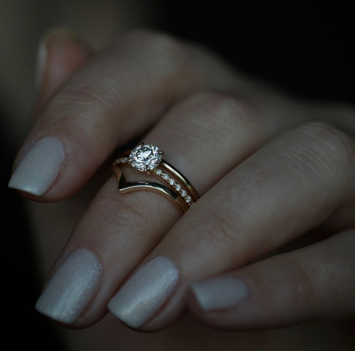 Round solitaire engagement ring viewed from the side